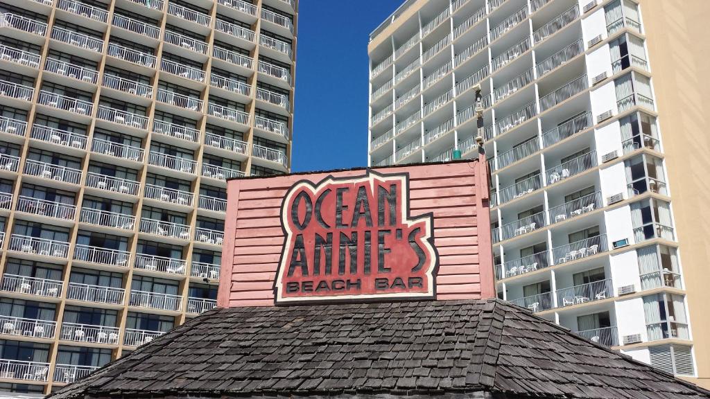 a pink building with a sign on top of it at Ocean Annie's Resorts in Myrtle Beach