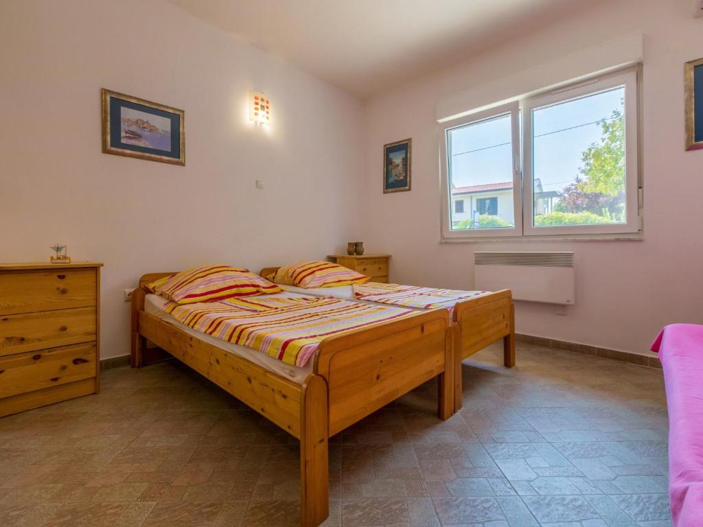 Postel nebo postele na pokoji v ubytování Apartments Ksenija