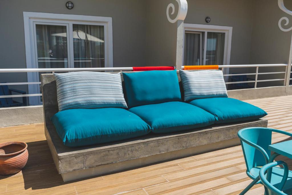 a blue couch with pillows on a balcony at Star inn Peniche in Peniche