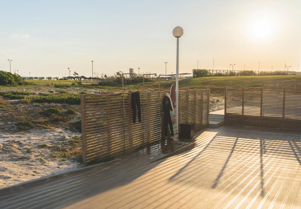 a wooden deck with a fence on the beach at Star inn Peniche in Peniche