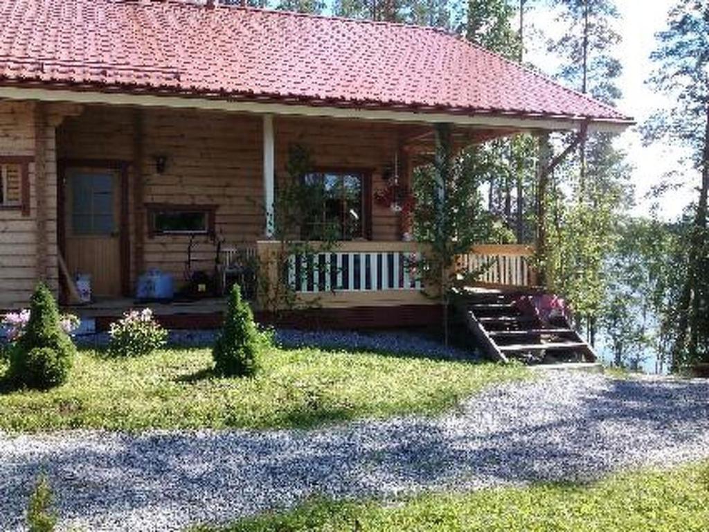 a small house with a porch and stairs to it at Holiday Home Käkiharju by Interhome in Sulkava