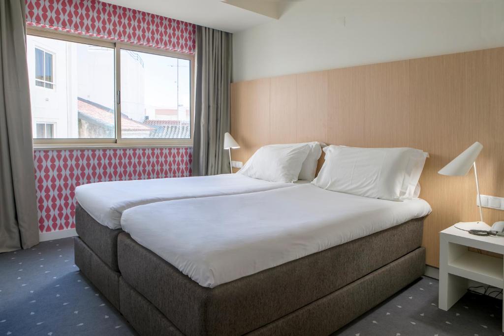 Posteľ alebo postele v izbe v ubytovaní Stay Hotel Faro Centro