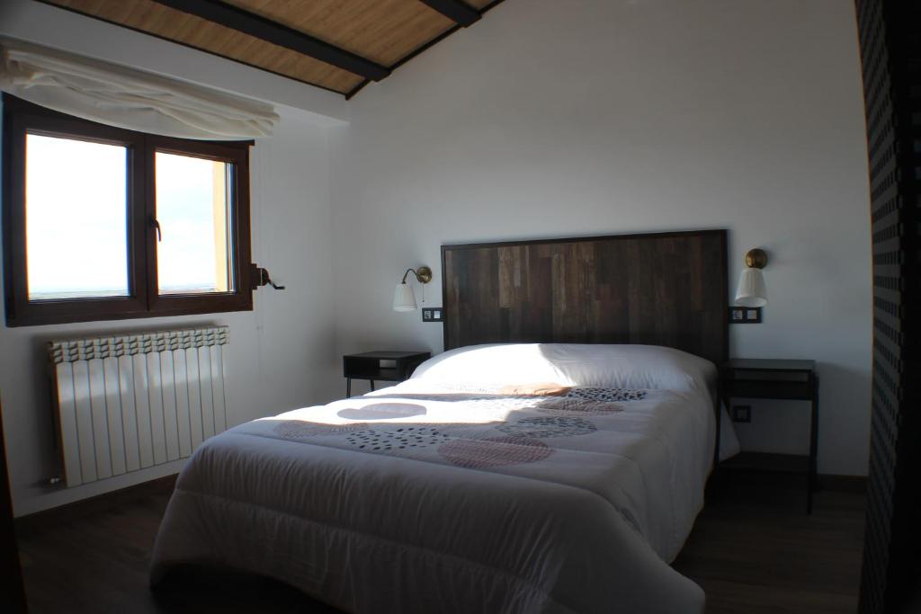 A bed or beds in a room at Casa Rural Atalaya House