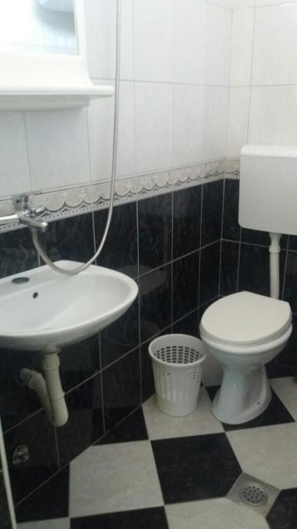 a bathroom with a toilet and a sink at Guesthouse Stankovic in Sutomore