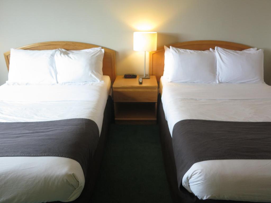 Postel nebo postele na pokoji v ubytování Cassandra Hotel