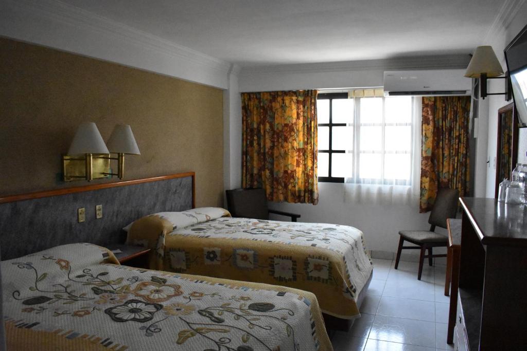Postel nebo postele na pokoji v ubytování Hotel Baluarte
