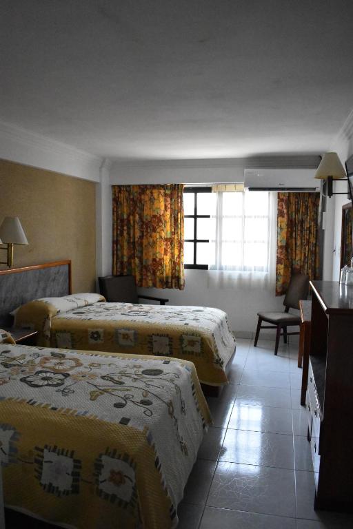 Postel nebo postele na pokoji v ubytování Hotel Baluarte