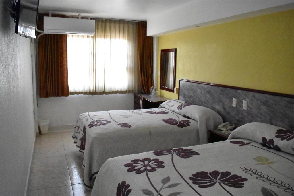 Postel nebo postele na pokoji v ubytování Hotel Baluarte