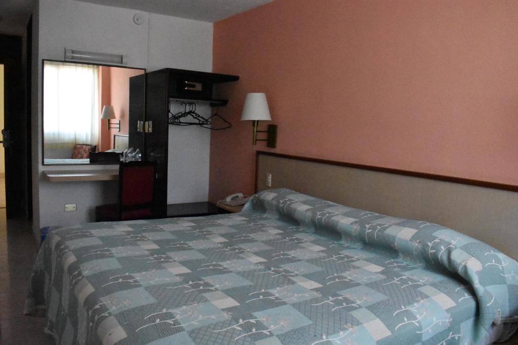 Postel nebo postele na pokoji v ubytování Hotel Baluarte