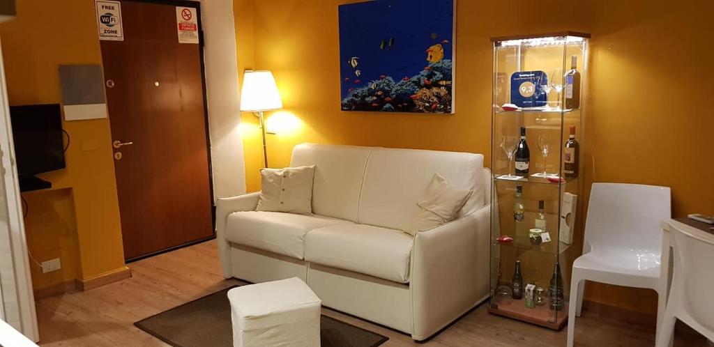 a living room with a white couch and a lamp at Sky-Inn in La Spezia