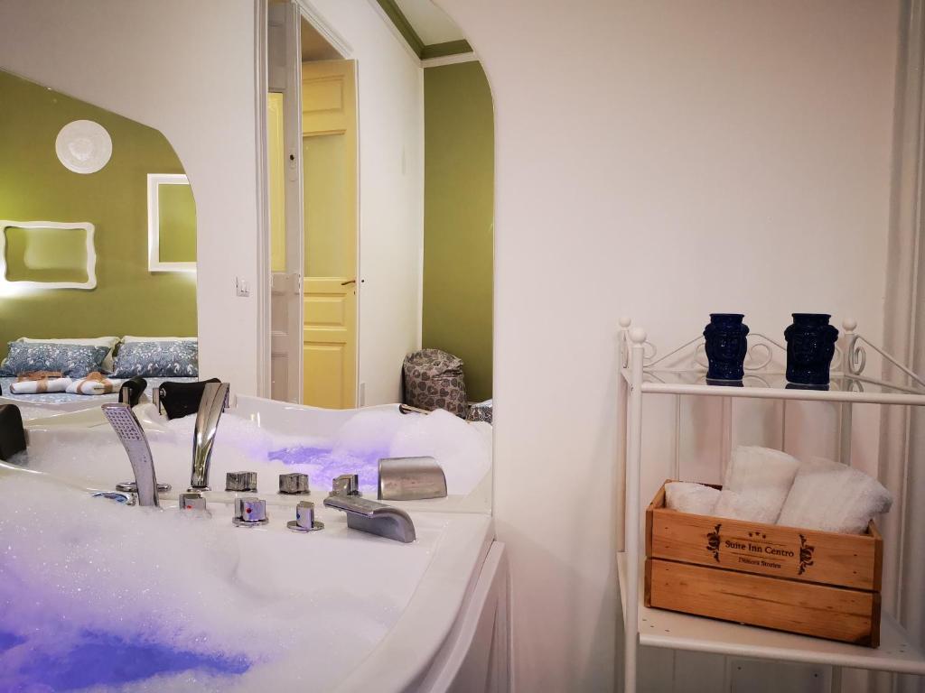 A bed or beds in a room at Suite Inn Centro Dimora Storica