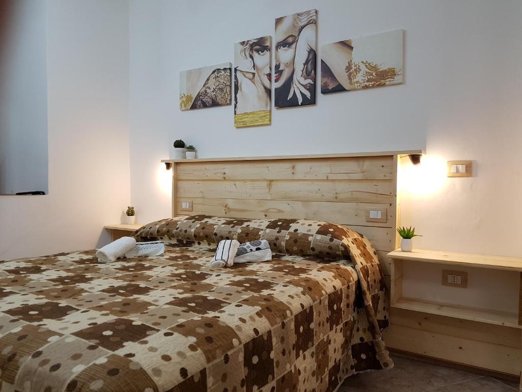 a bedroom with a bed and two tables at B&B Casa Alessandro in Scalea