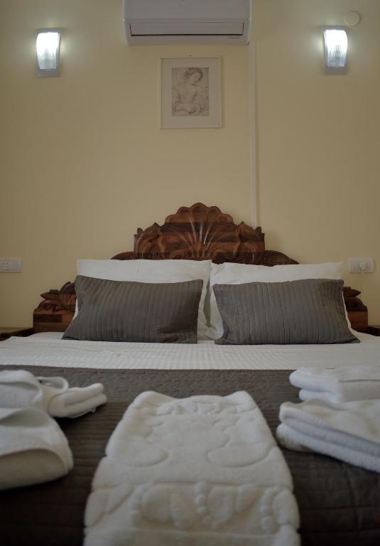 a bedroom with a bed with towels on it at Hotel &quot;VIR&quot; in Velika Plana