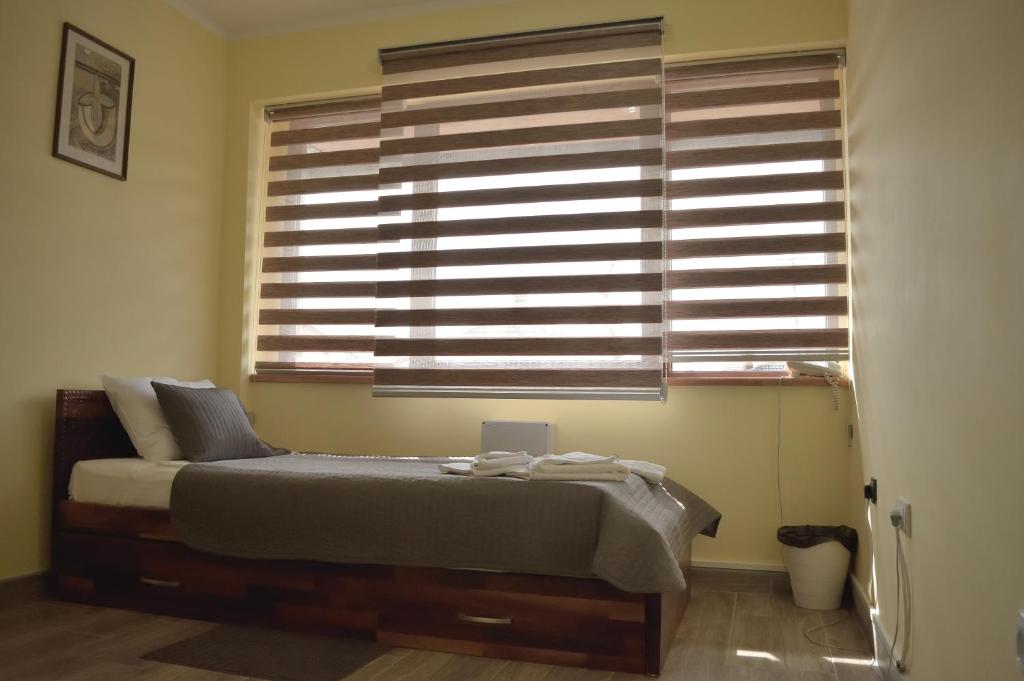 a bedroom with a bed and a large window at Hotel &quot;VIR&quot; in Velika Plana