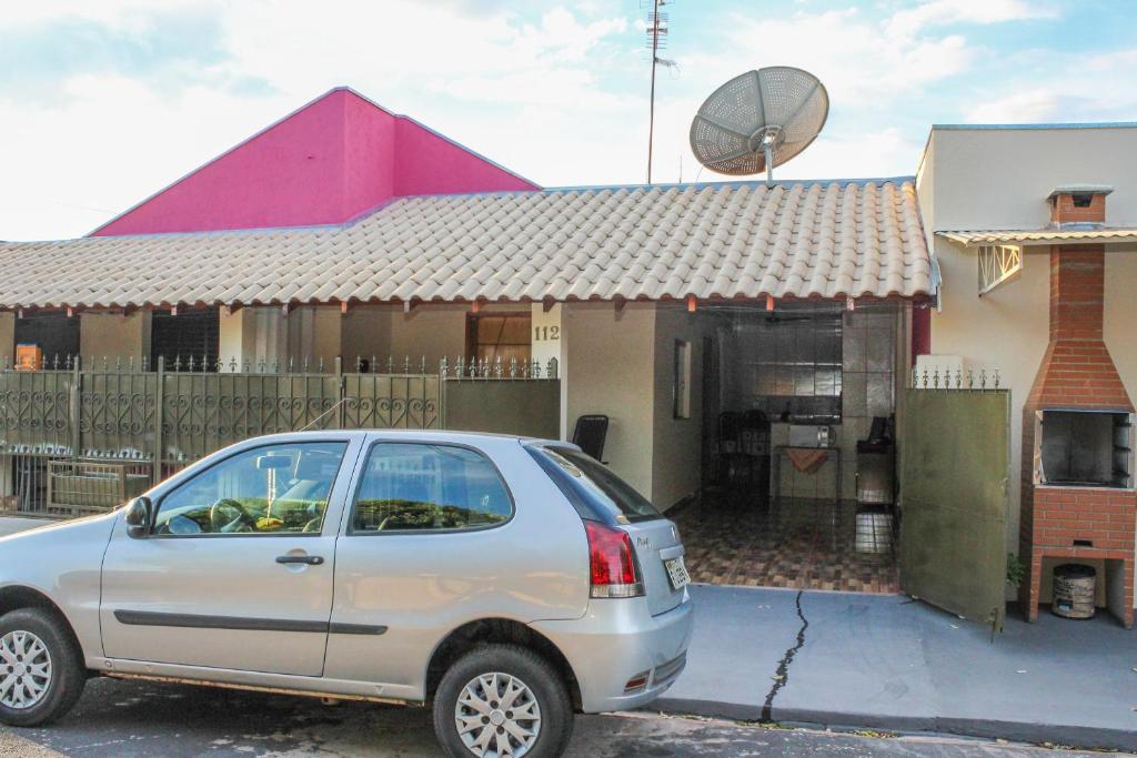 a car parked in front of a house at Casas Da Vó Maria in Olímpia