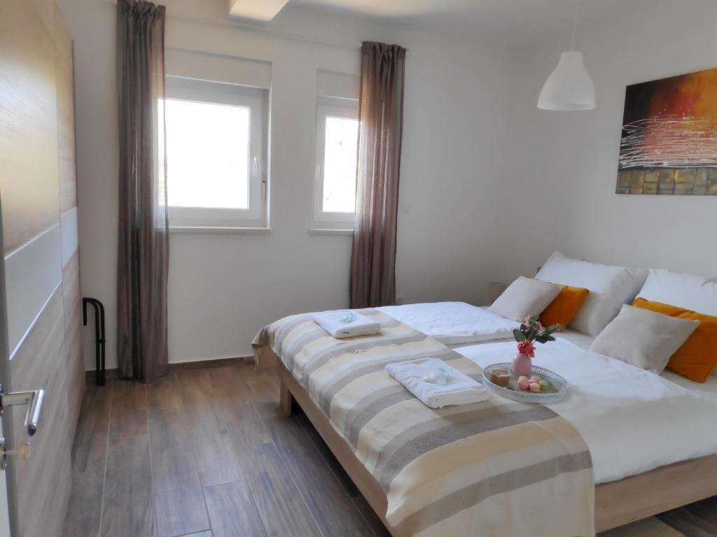 Łóżko lub łóżka w pokoju w obiekcie Maristo Apartments