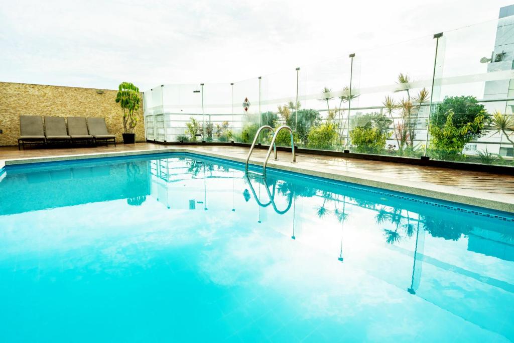 a swimming pool on top of a building at Jose Antonio Executive in Lima