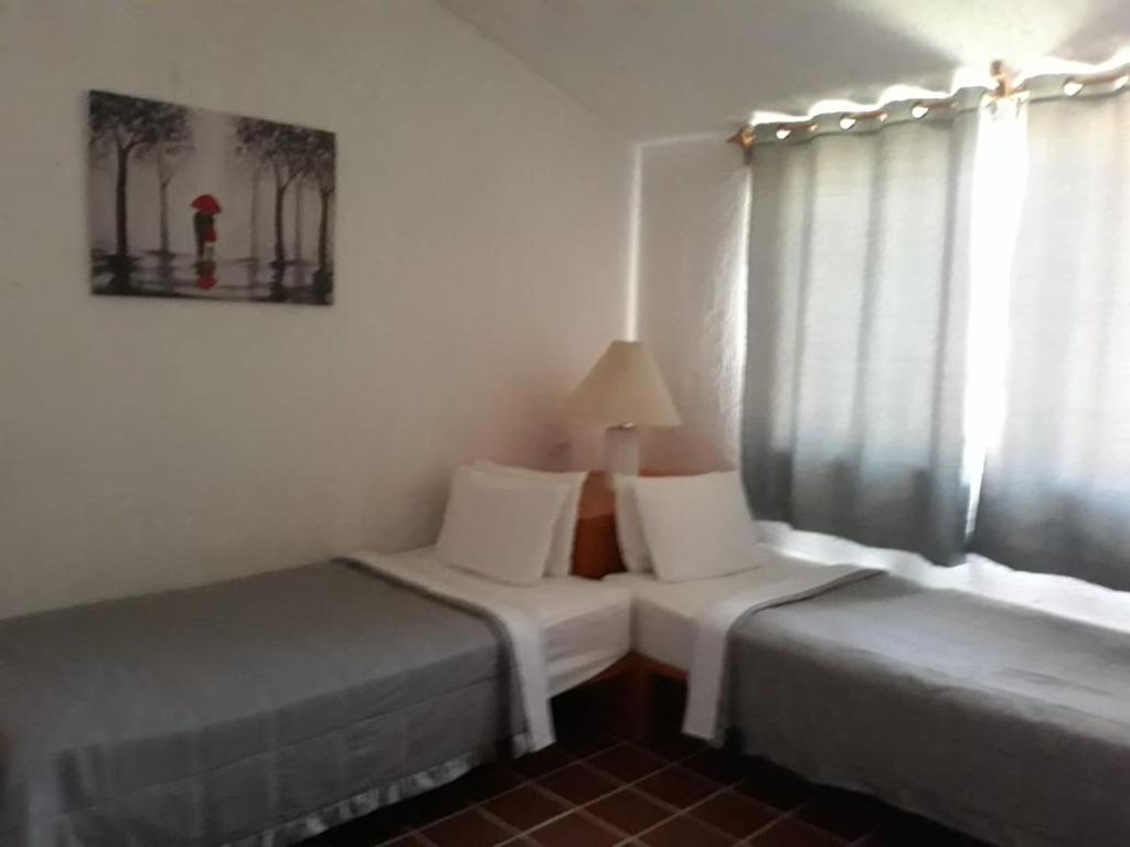 Postel nebo postele na pokoji v ubytování Hotel La Rinconada Tequisquiapan