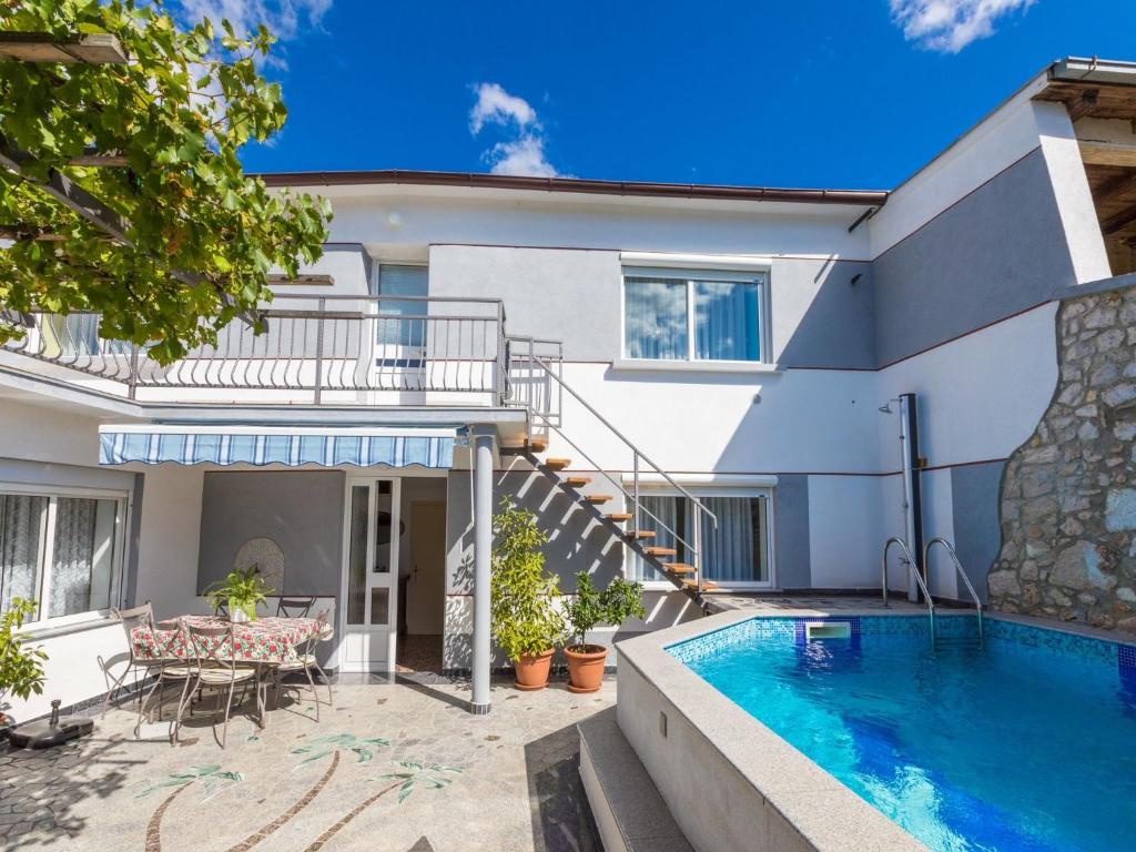 a house with a swimming pool and a patio at House Delfin in Tribalj