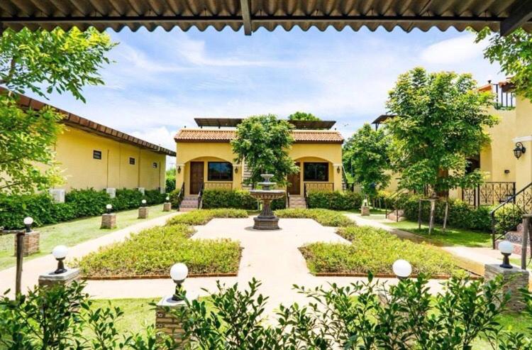 a courtyard with a fountain in the middle of a building at Sierra View Resort in Ban Khanong Phra Nua