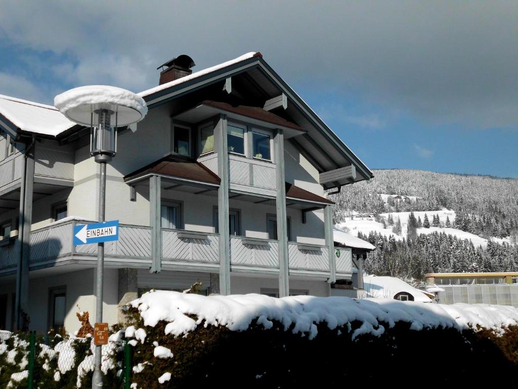 a snow covered building with a sign in front of it at Appartement Pürstinger in Altenmarkt im Pongau