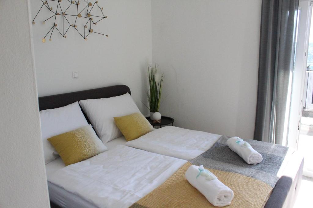 Łóżko lub łóżka w pokoju w obiekcie Maristo Apartments