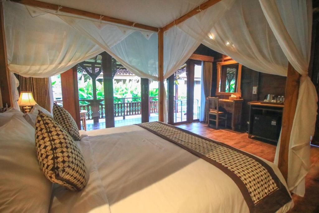 Postel nebo postele na pokoji v ubytování Ari Cottages Ubud