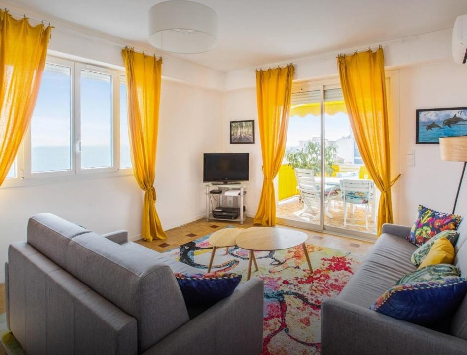 a living room with two couches and a table at Stunning 2 bed Flat Nice front of the beach Seaview in Nice