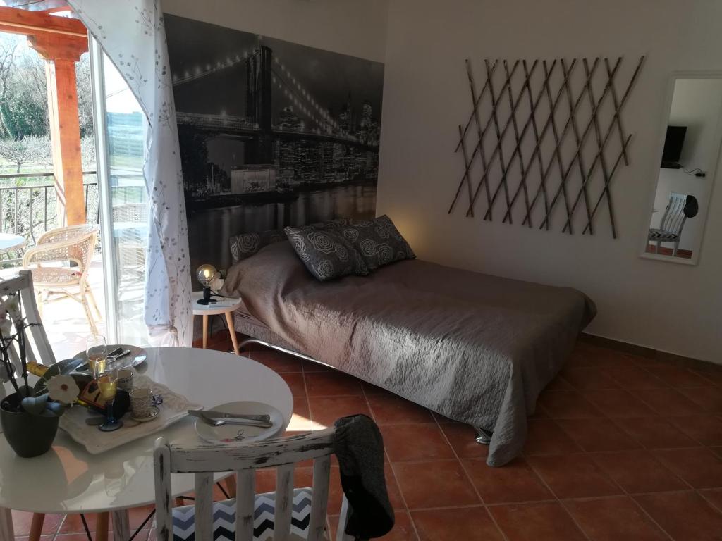 a bedroom with a bed and a table and a table and a tableablish at Guesthouse Porec in Poreč