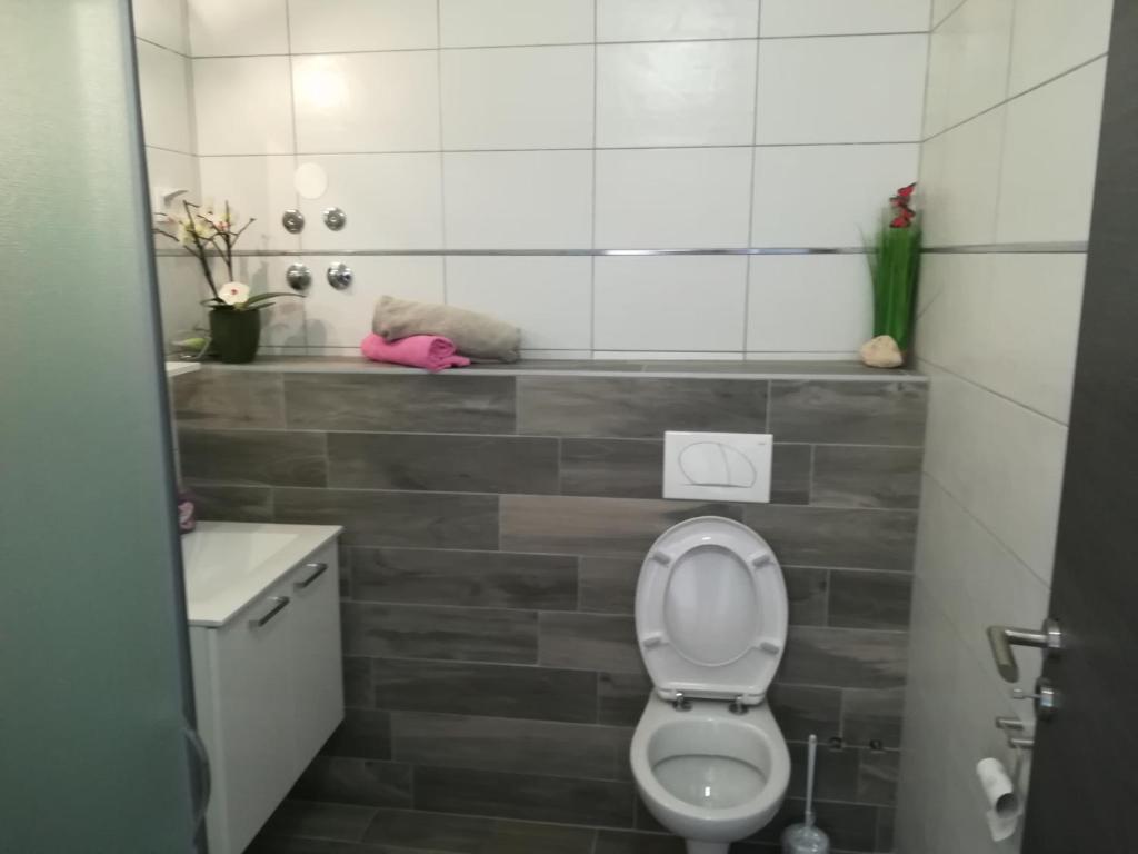 a bathroom with a toilet and a sink at Guesthouse Porec in Poreč