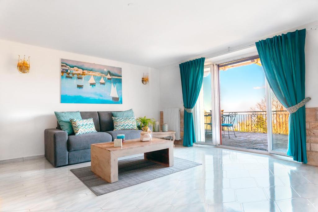 a living room with a couch and a table at Villa Rossella Sorrento in Sorrento