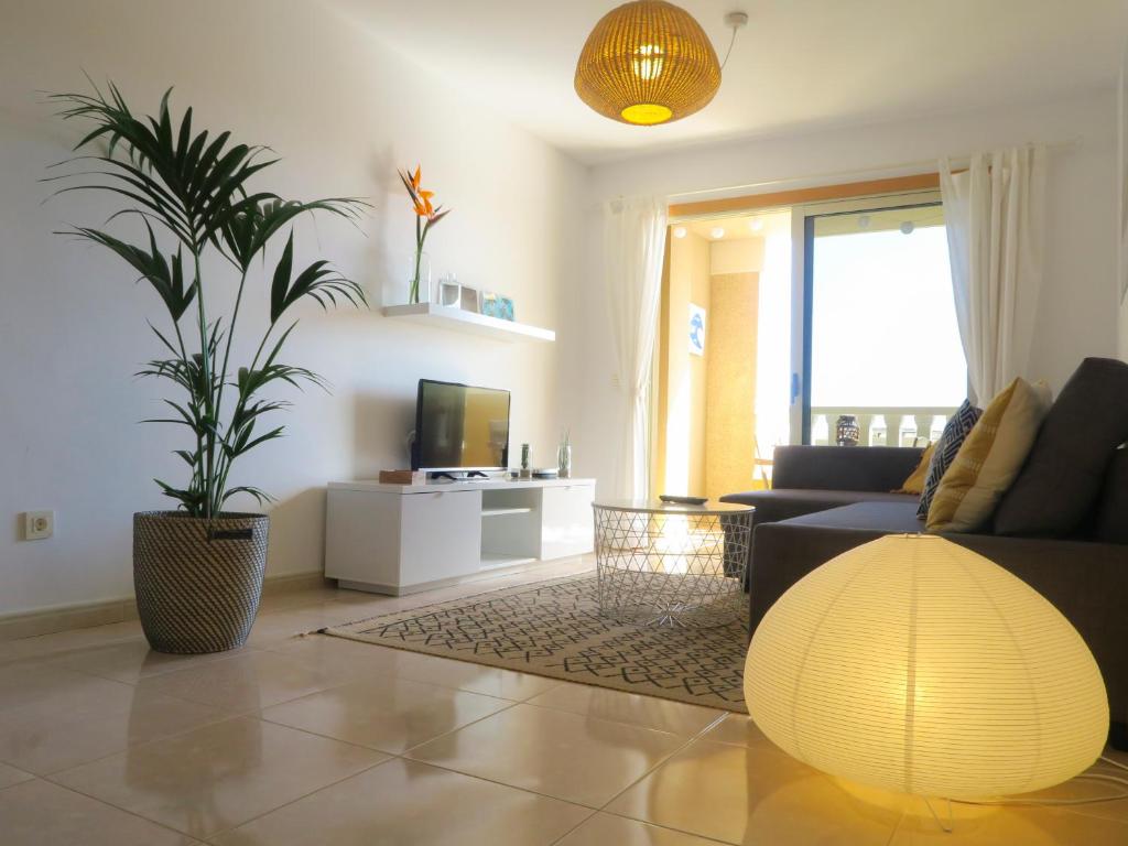 a living room with a couch and a potted plant at MEDANO4YOU Pearl Flavour Holiday Home in El Médano