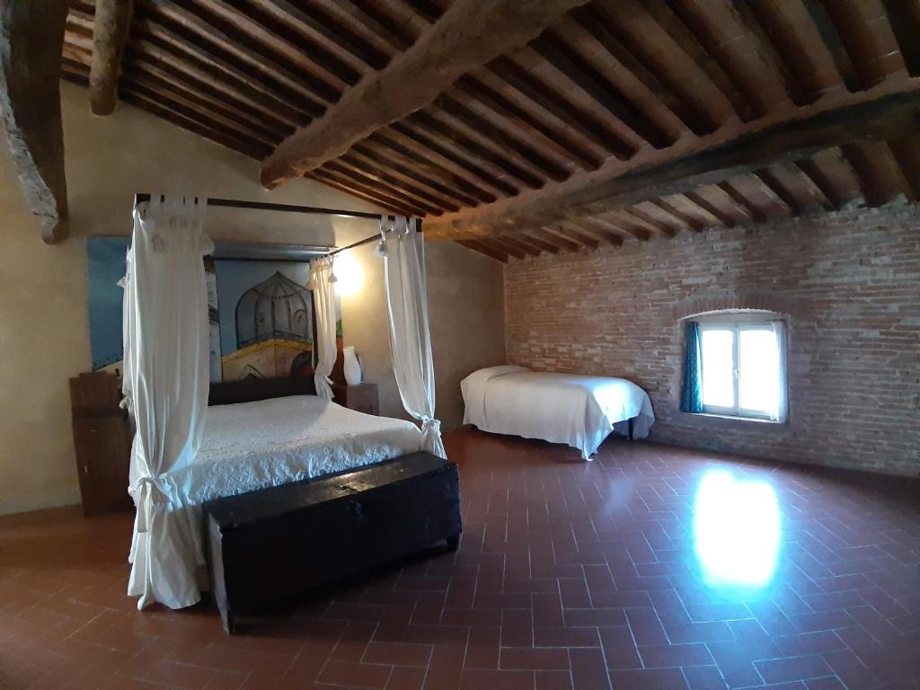 Postel nebo postele na pokoji v ubytování B&B Glicine e Luna