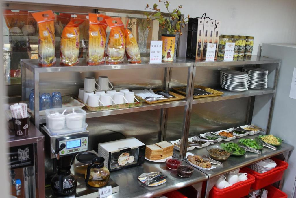 a shelf filled with dishes and food in a kitchen at Yilan Pine Villa Homestay in Luodong