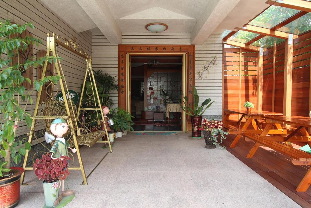a porch of a house with plants on it at Yilan Pine Villa Homestay in Luodong