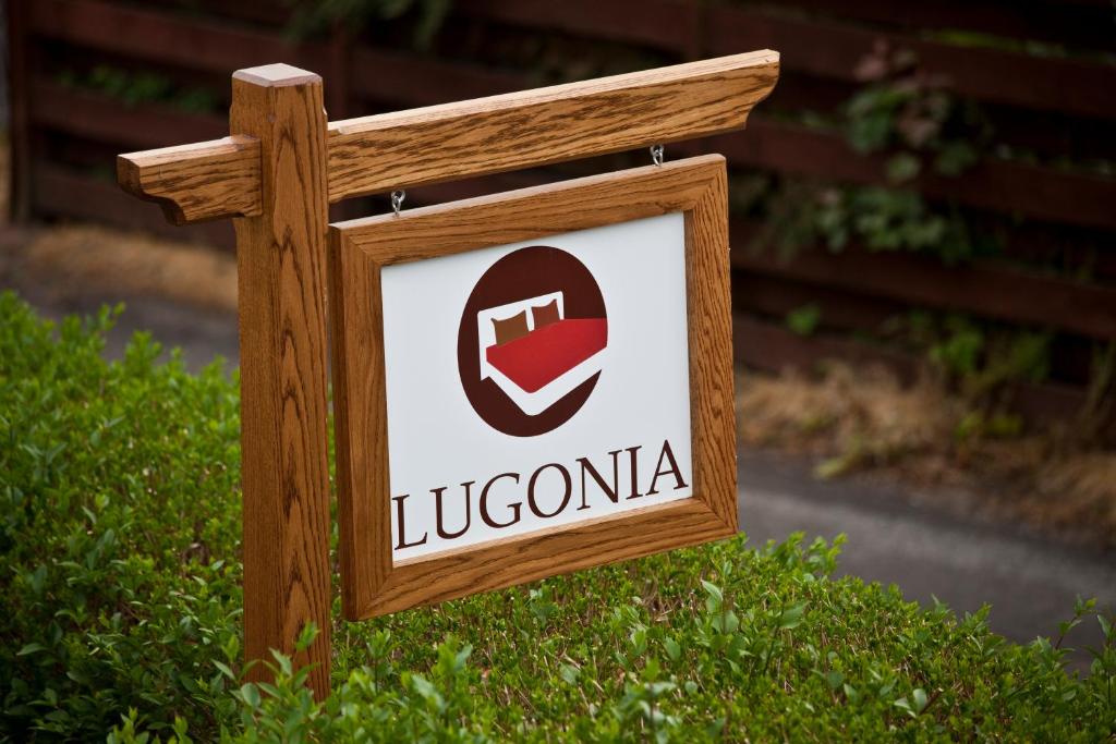 a wooden sign with a lucciania logo on it at Lugonia in Pitlochry