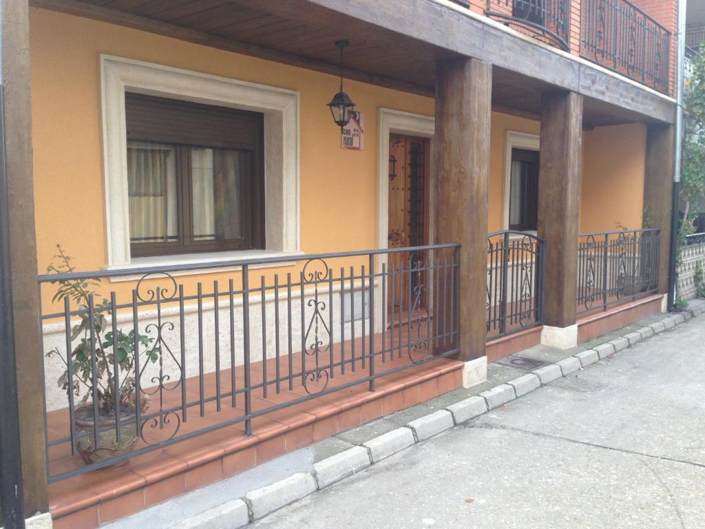 a porch of a house with a balcony at CASA RURAL LA IBIENZA in Zarzuela del Pinar