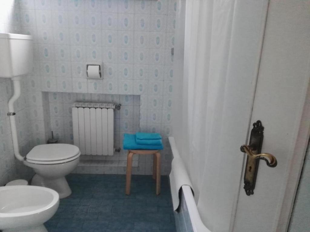 a small bathroom with a toilet and a sink at Casa Flora in Diano Marina