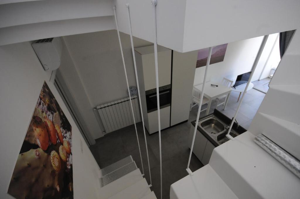 a room with a staircase with a desk and a mirror at Appartamenti porta mare in Otranto