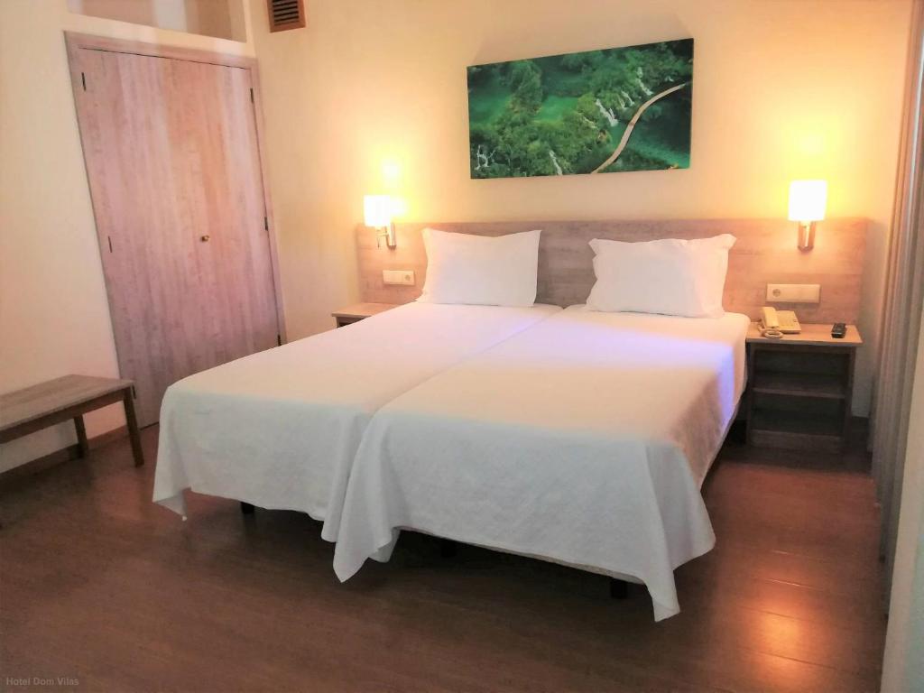 Postel nebo postele na pokoji v ubytování Hotel Dom Vilas