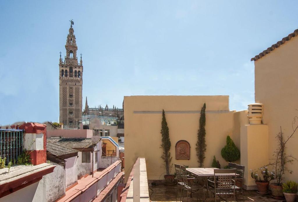 a view from the roof of a building with a clock tower at BOTANIC DUPLEX TERRACE 5 PAX in Seville