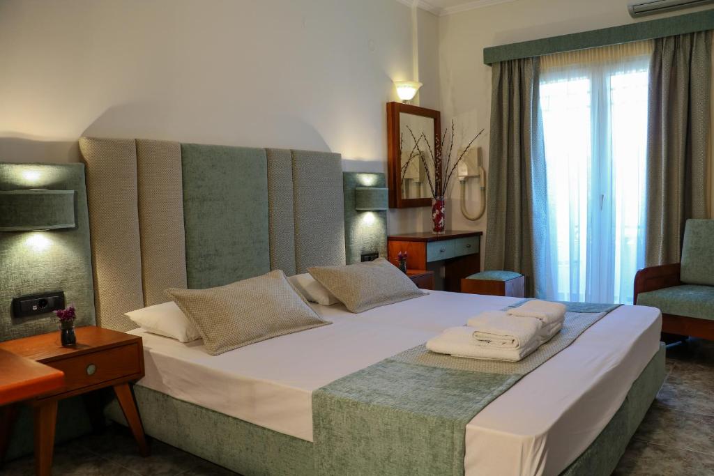 Postel nebo postele na pokoji v ubytování Hotel Dionysis Studios