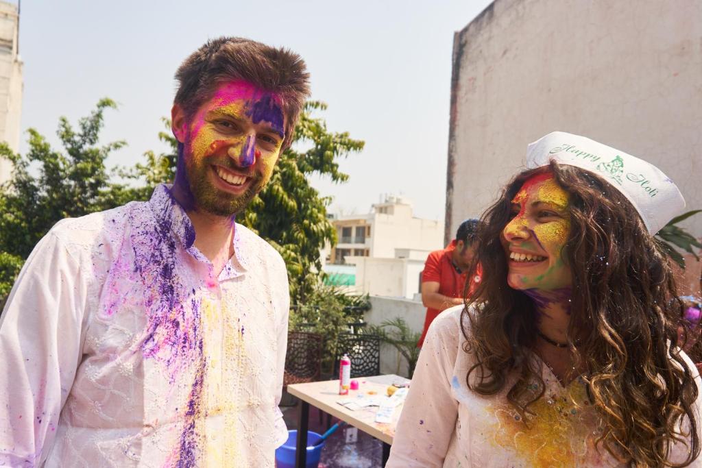 a man and a woman covered in holi paint at The Desire Hostel in New Delhi