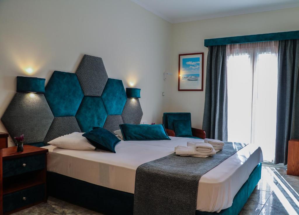 Postel nebo postele na pokoji v ubytování Hotel Dionysis Studios