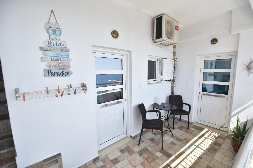 a small dining room with a table and chairs at House With View in Paránimfoi
