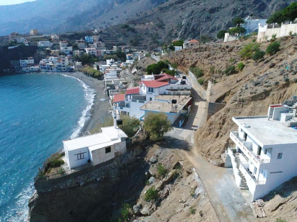 a group of houses on a hill next to the ocean at House With View in Paránimfoi