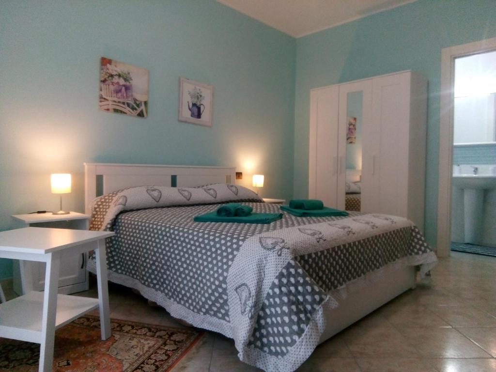 a bedroom with a bed and a table and a window at B&b la finestra sul mare in Capo dʼOrlando