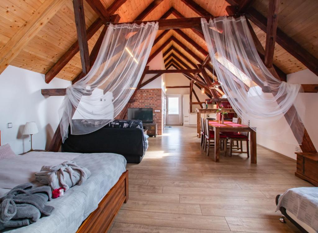 a bedroom with two beds with mosquito nets in it at Penzion Na barokní cestě Wellness & Spa in Plasy