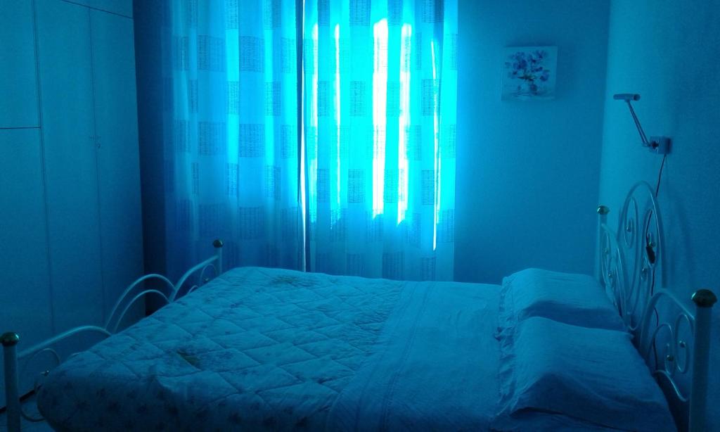 A bed or beds in a room at Appartamento Lauretta