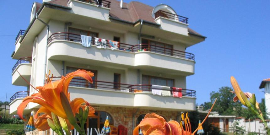 a building with a dragon statue in front of it at Victoria Sinemorets Guest House in Sinemorets